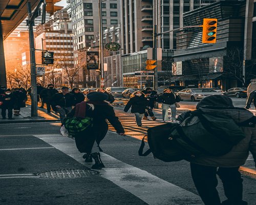 Busy city street with people walking and moving around responsibly