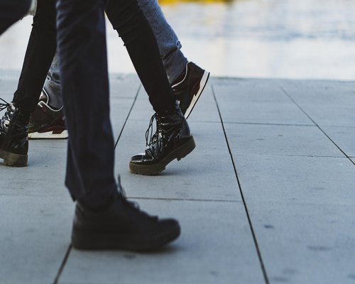 Close-up of comfortable dynamic footwear walking on a modern urban pavement